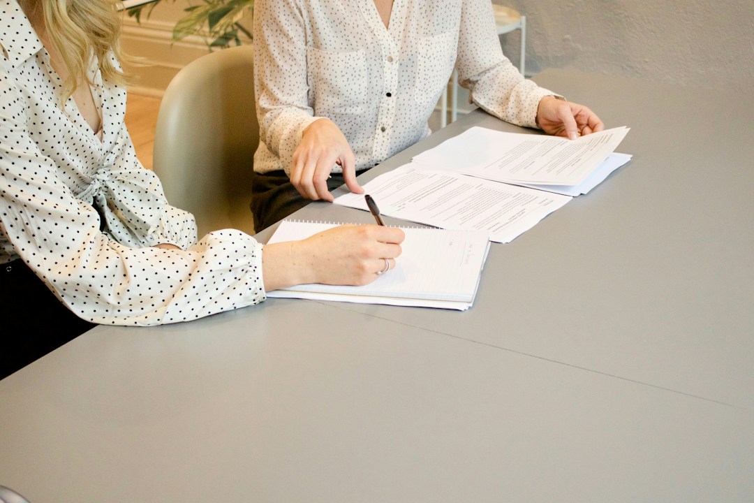 Person reviewing a written agreement before signing